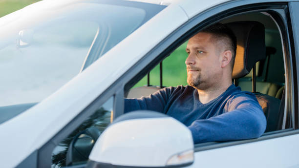 istock Mid adult man driving his car 1159437905