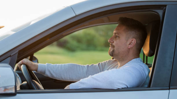 istock Mid adult man driving his car 1159437962