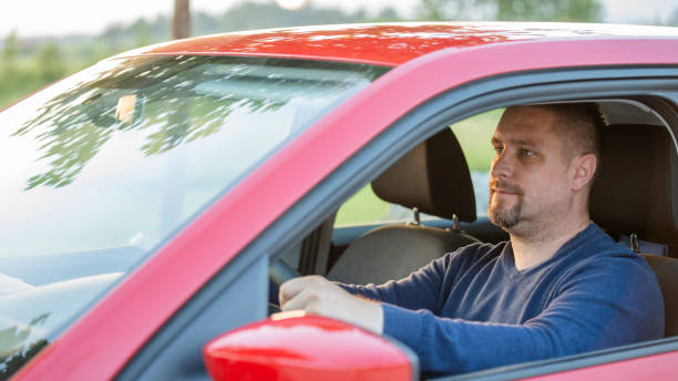 istock Mid adult man driving his car 1159438068