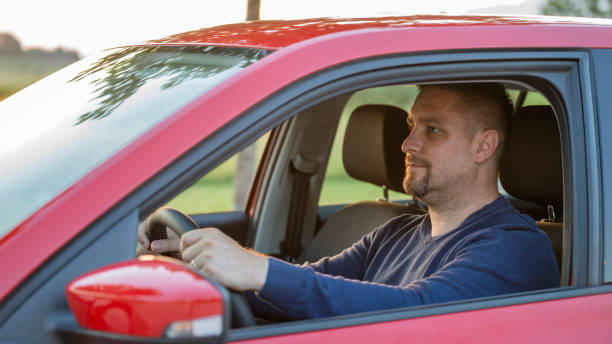 istock Mid adult man driving his car 1159438109