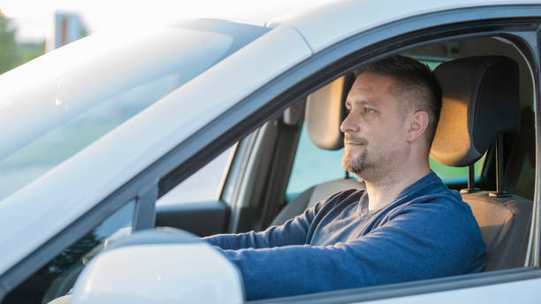 istock Mid adult man driving his car 1159438239