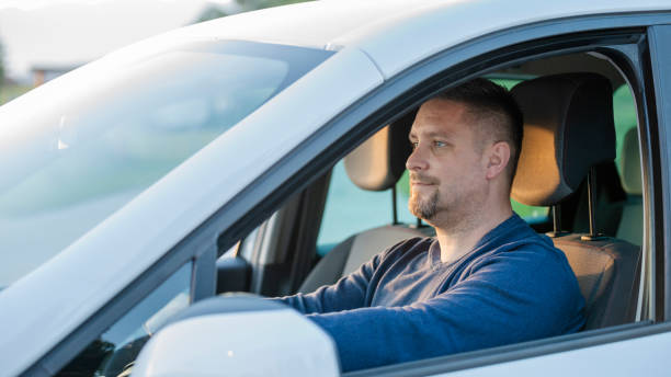 istock Mid adult man driving his car 1159438240