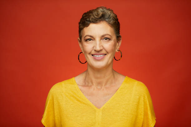 istock Middle aged sophisticated woman studio headshot looking at camera. 1159438246