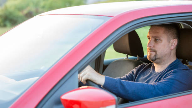 istock Mid adult man driving his car 1159438311