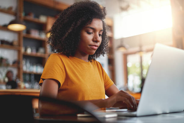 istock Young afro-american woman working on her laptop 1159439584