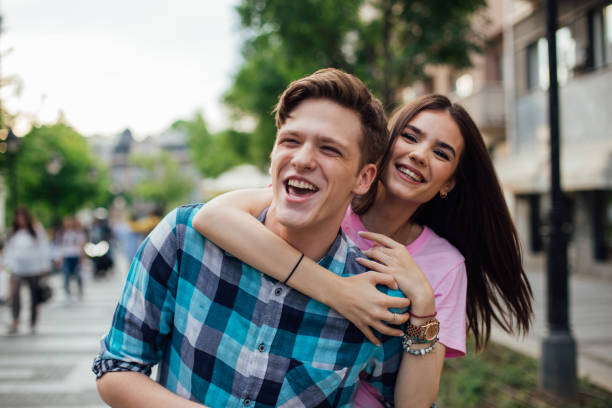 istock Smiling girl hugging boyfriend 1159442047