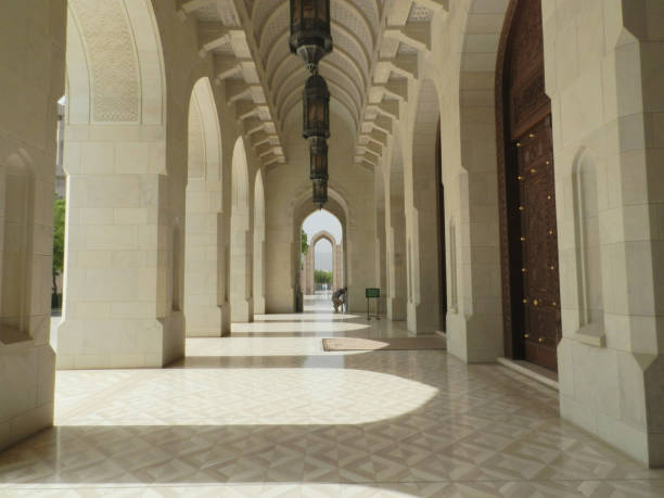 istock Arched Hallway with Man Praying at the Sultan Qaboos Mosque, Muscat, Oman 1159442086