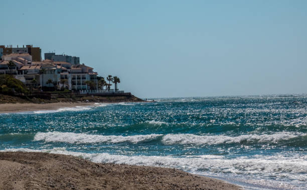 istock Spanish beach with  Sea waves shining in sun beams 1159444965