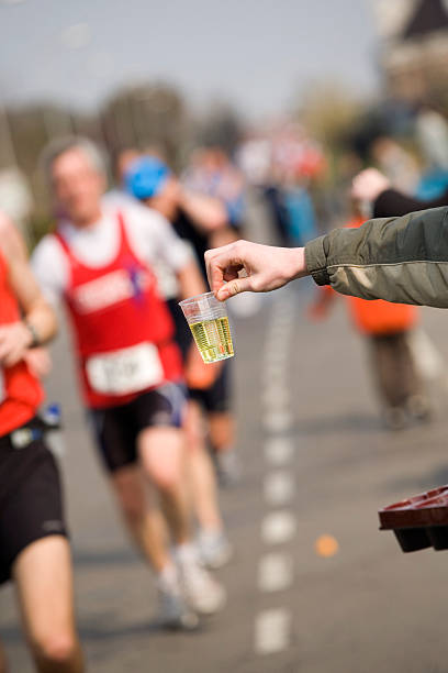istock cool sport drink offered to runners at a marathon 115944608