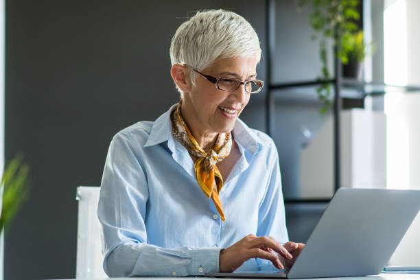 istock Senior businesswoman working at office 1159448113