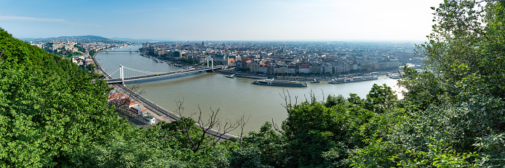 Budapest, Hungary - June 10 2019: Panorama of Budapest on a bright hot morning, overlooking the river Danube and landmarks such as Buda Castle, The Hungarian Parliament Building and Elisabeth Bridge.
