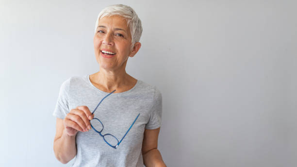 Happy mid woman against grey background with copy space