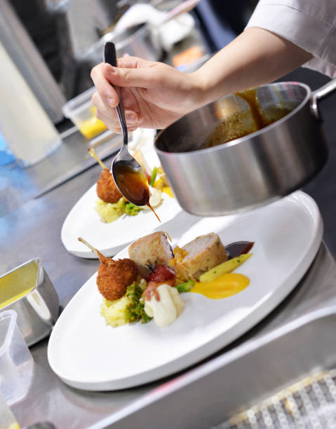 istock Chef preparing food in the kitchen, chef cooking, Chef decorating dish 1159449212