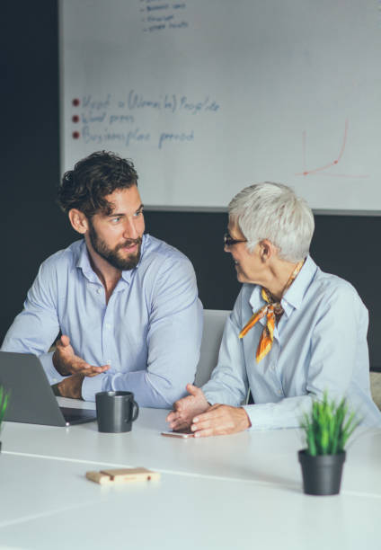 istock Colleagues meeting in office and discussing over a report 1159449274