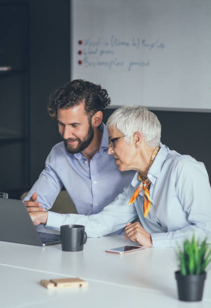 istock Colleagues meeting in office and discussing over a report 1159449330