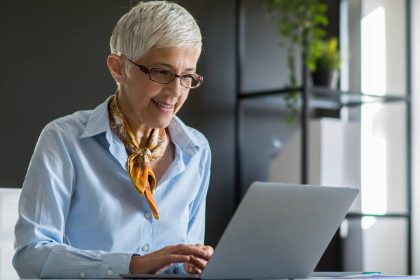 istock Senior businesswoman working at office 1159449443