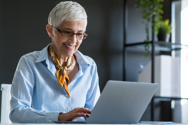 istock Senior businesswoman working at office 1159449615