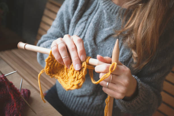 istock Close up on woman's hands knitting 1159449746