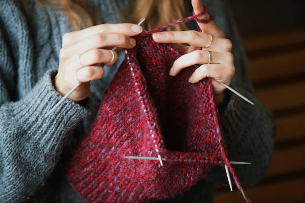 istock Close up on woman's hands knitting 1159449757