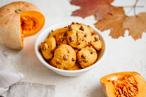 istock Pumpkin cookies with chocolate chips made from cake mix in a white ceramic bowl. 1159449783