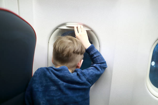 istock Child looks out porthole 1159450850