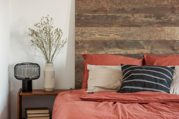 istock Beautiful bedroom interior with king size bed wooden headboard 1159452408