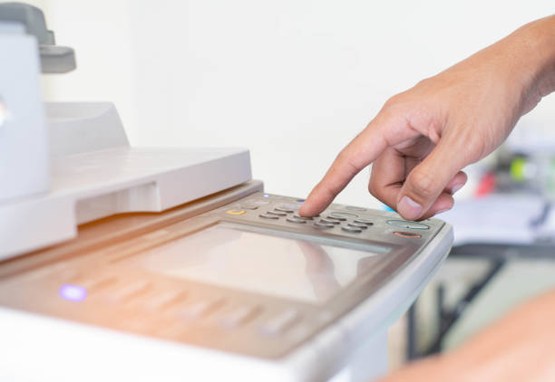 istock a man is pressing the botton of printer 1159453367