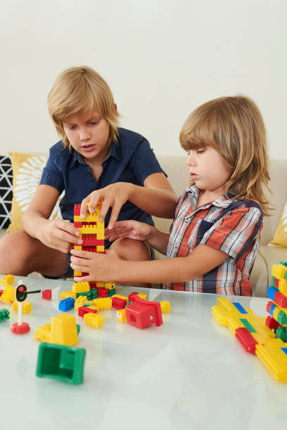 istock Brothers builiding tower together 1159453595