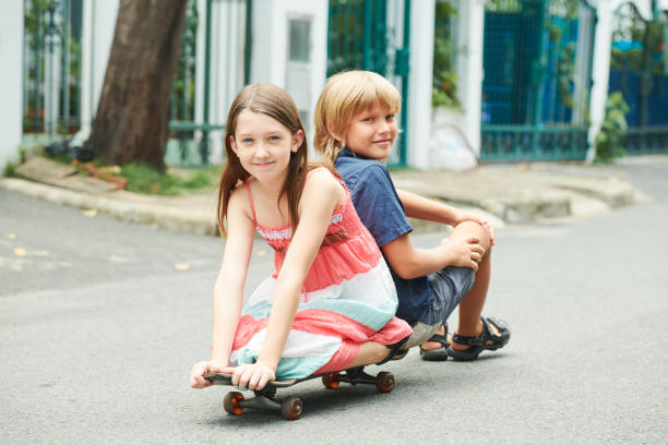istock Cheerful children on skateboard 1159453645