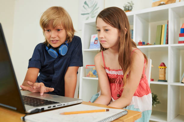 istock Preteen boy helping classmate 1159453698