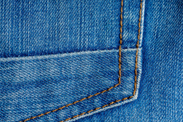 istock Elements of denim trousers. Blue cotton fabric. Creative vintage background. 1159453972