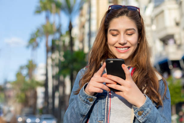 istock Young woman texting on the phone 1159454910