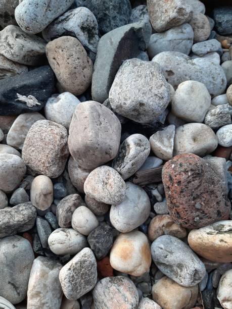 istock Pattern of colorful pebbles near the river 1159455270