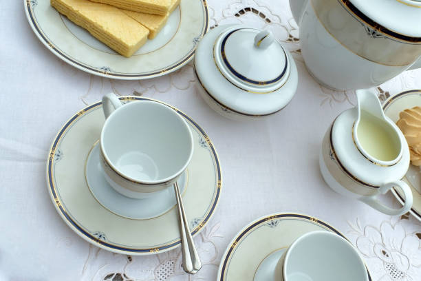 istock Served coffee table. On the table, a coffee pot, two cups and saucers, a milkman, a sugar bowl, small spoons, a plate of marshmallows and a plate with waffles. 1159456636