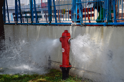 Antalya, Turkey - May 20, 2019: Open fire hydrant, water flows from a fire hydrant