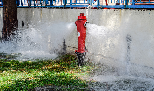 Open fire hydrant, water flows from a fire hydrant