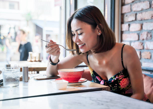 istock Asian Woman drinking soup in restaurant 1159459379