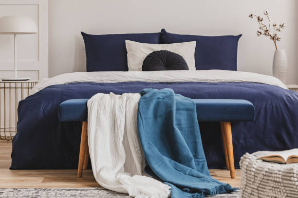 istock Light blue and white blanket on bench in elegant bedroom 1159461433