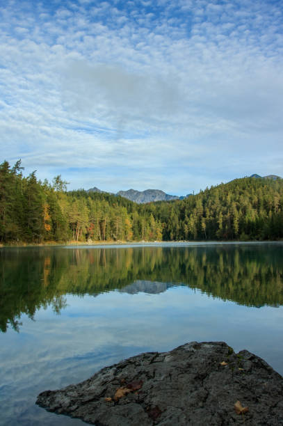 istock Reflections of the alps in a mountain lake 1159461499