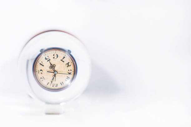 Time abstraction. Glass balls with clock reflections.