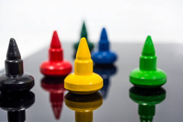 Colorful play figures on black mirror board