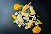 Banana mango ice cream with fruits and ices