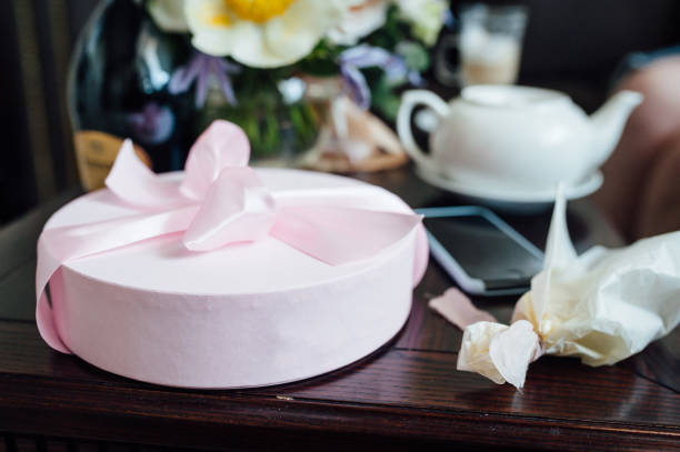 istock White box with fresh flowers and macarons. 1159463308