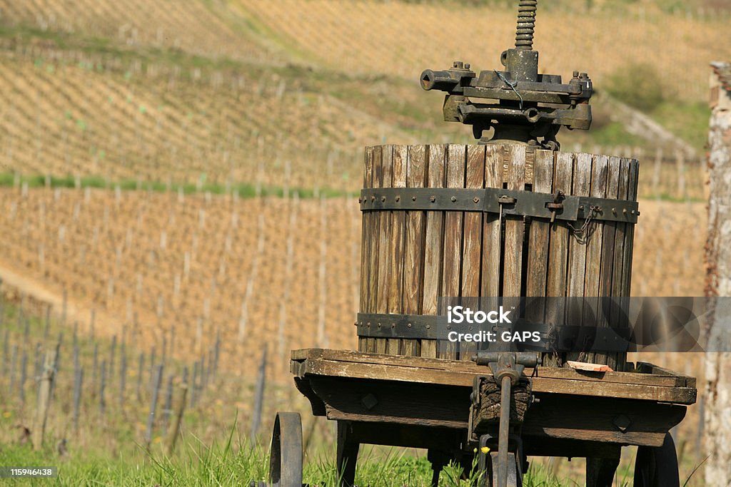 old wooden winepress in front of the vineyards old wooden winepress in front of the vineyards; Burgundy, France Agricultural Equipment Stock Photo