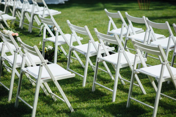 istock Outgoing wedding ceremony. Decor Studio. white wooden chairs on a green lawn. 1159464989