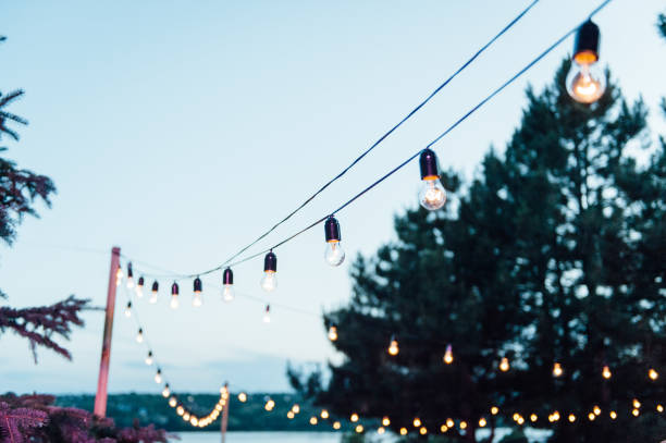 istock Light bulb decor in outdoor party, Wedding party 1159466144
