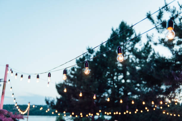 istock Light bulb decor in outdoor party, Wedding party 1159466148