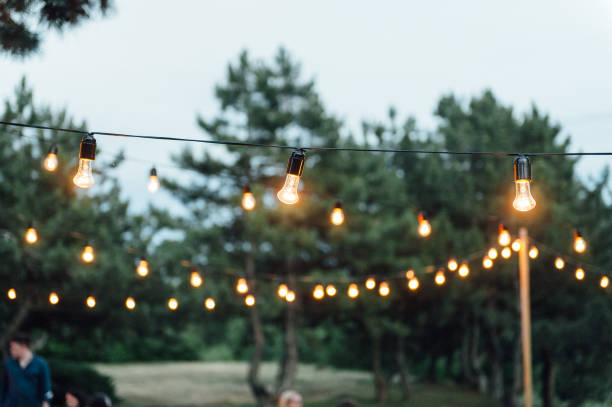 istock Light bulb decor in outdoor party, Wedding party 1159466368