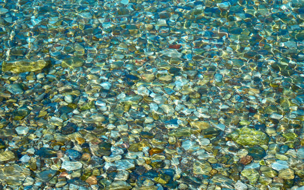 pebbles in sea stock photo