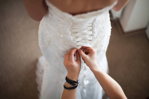 istock Lacing the wedding dress. 1159472614